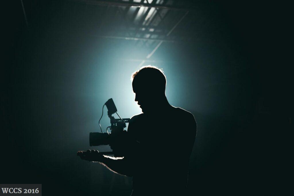 Silhouette of Man Standing in Front of Microphone