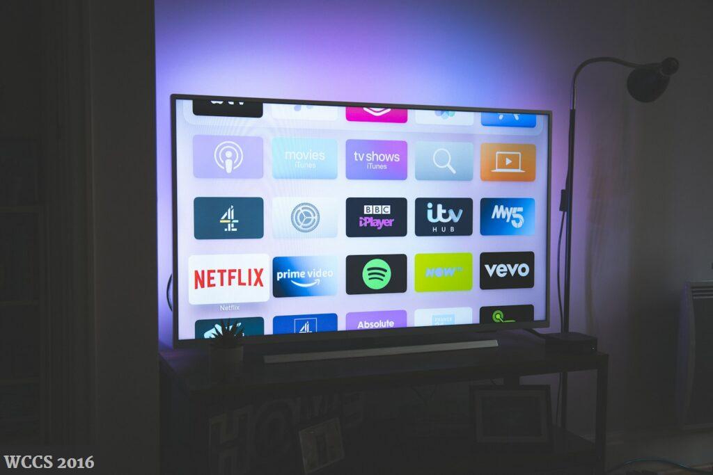 black flat screen tv turned on showing game